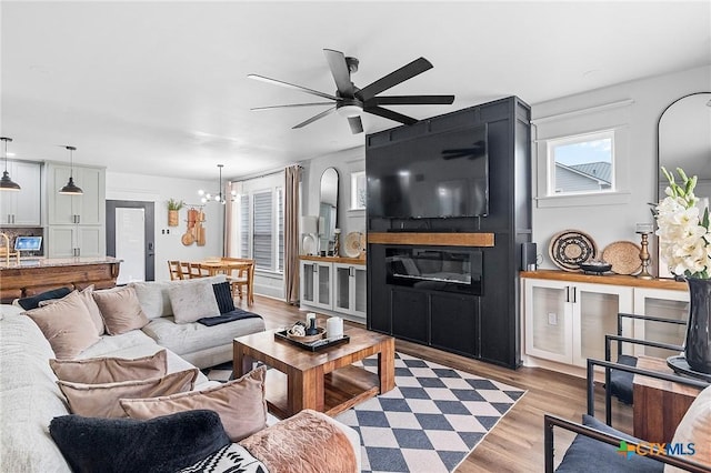 1611 Port Lavaca Dr, Victoria, TX 77901 - living room featuring light wood-style flooring, a ceiling fan, and a chandelier