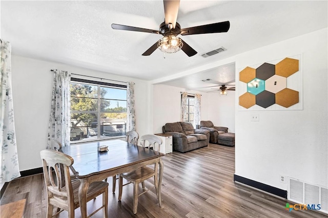 dining room with visible vents, baseboards, and wood finished floors