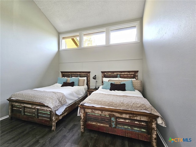 bedroom with dark wood-type flooring, a textured ceiling, and lofted ceiling