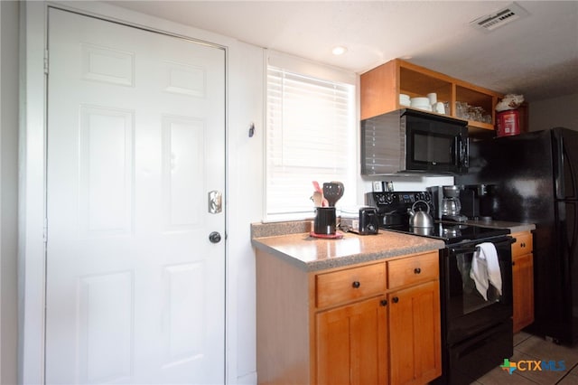 kitchen featuring black appliances and tile patterned flooring