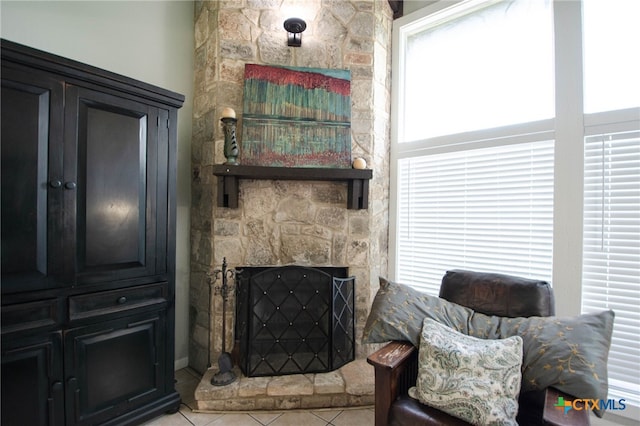 sitting room with a fireplace and light tile patterned flooring