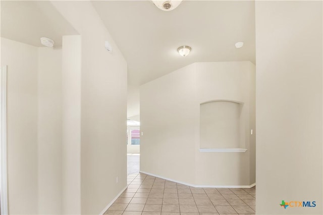 hall with light tile patterned floors