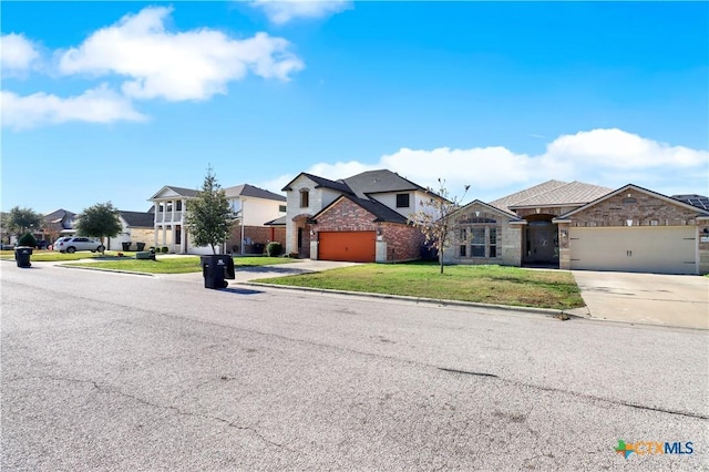 view of front of property featuring a front yard and a garage