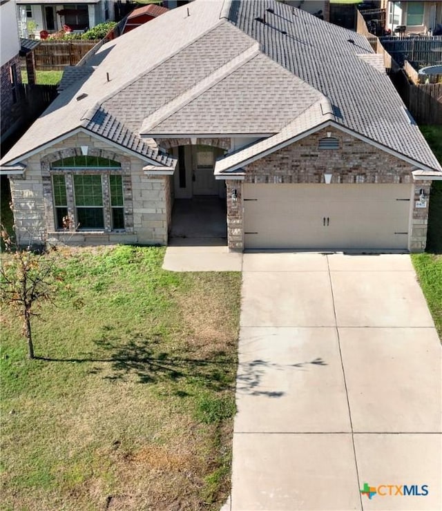 view of front of house with a garage and a front lawn