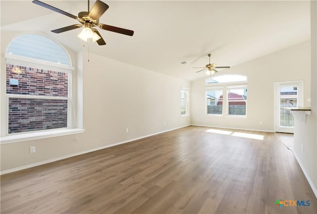 unfurnished living room with ceiling fan, lofted ceiling, and hardwood / wood-style floors