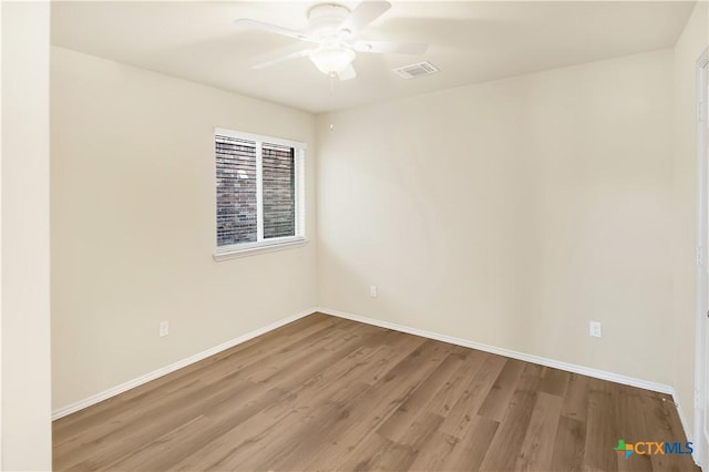 spare room with light hardwood / wood-style flooring and ceiling fan