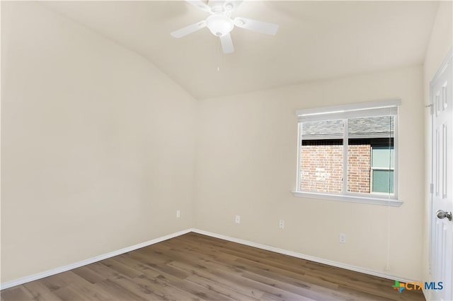 empty room with hardwood / wood-style flooring, ceiling fan, and vaulted ceiling