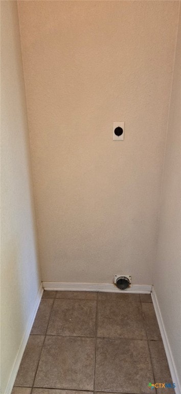 washroom with hookup for an electric dryer and tile patterned flooring