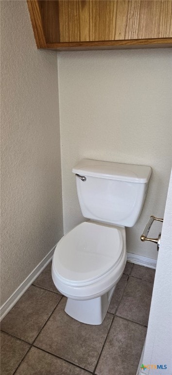 bathroom with tile patterned flooring and toilet