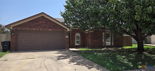 ranch-style house featuring a garage and a front lawn