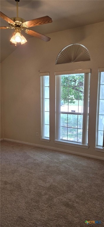 carpeted spare room with vaulted ceiling and ceiling fan