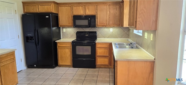 kitchen with black appliances, sink, tasteful backsplash, and light tile patterned floors