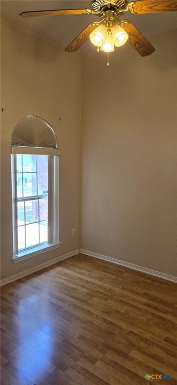 spare room with hardwood / wood-style floors and ceiling fan