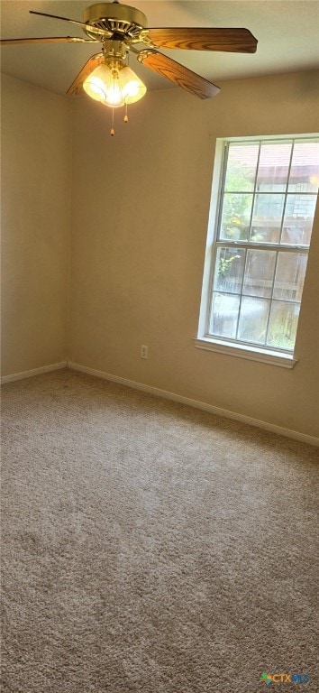 carpeted empty room featuring ceiling fan