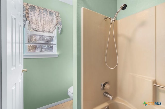 bathroom with baseboards, bathtub / shower combination, toilet, and tile patterned floors