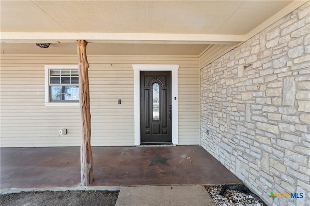 doorway to property with stone siding