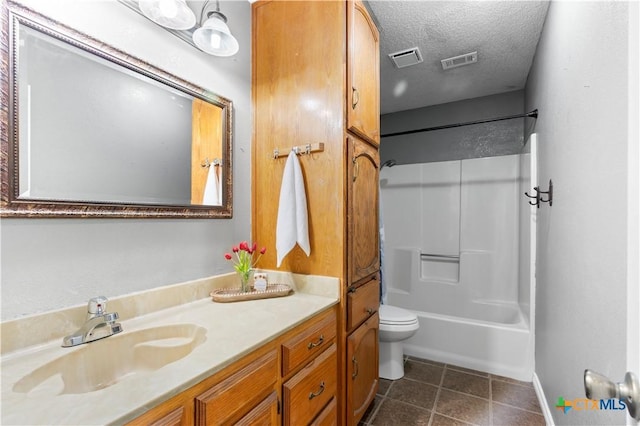 bathroom with tile patterned flooring, visible vents, a textured ceiling, and vanity