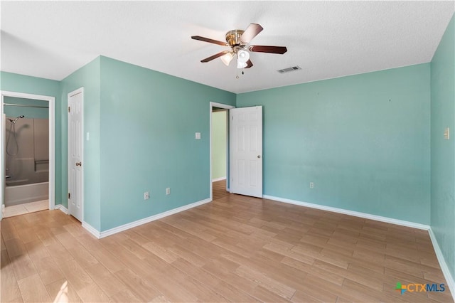 unfurnished bedroom featuring light wood-style floors, baseboards, and visible vents