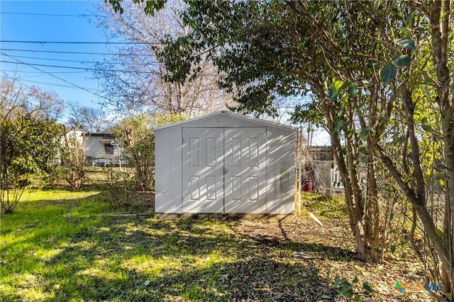 view of outbuilding featuring a yard