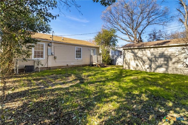 back of property featuring a lawn