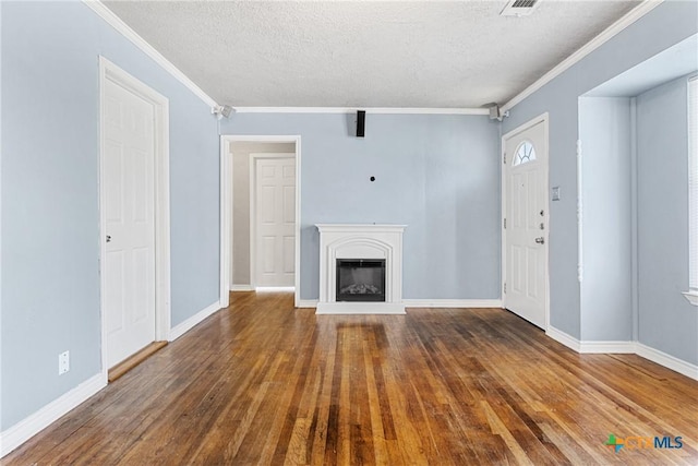 unfurnished living room with dark hardwood / wood-style flooring, crown molding, and a textured ceiling