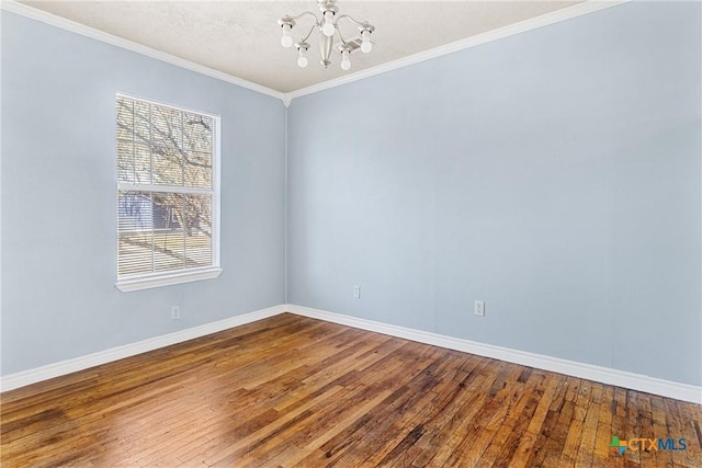 empty room featuring an inviting chandelier, ornamental molding, wood-type flooring, and a textured ceiling