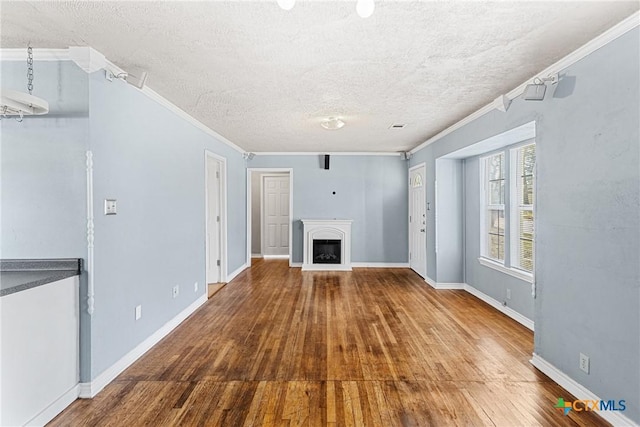 unfurnished living room featuring crown molding, hardwood / wood-style floors, and a textured ceiling