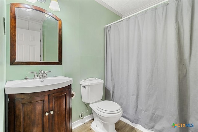 bathroom featuring walk in shower, vanity, toilet, and hardwood / wood-style floors