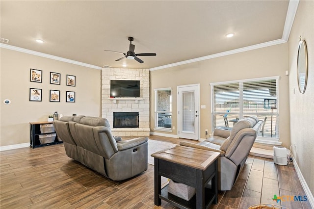 living room with ceiling fan, ornamental molding, and a fireplace