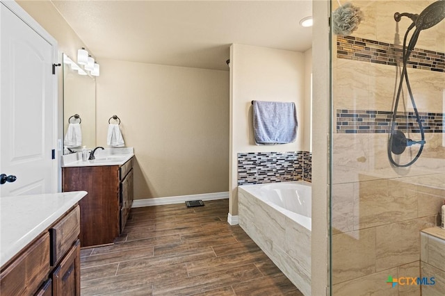 bathroom featuring separate shower and tub and vanity