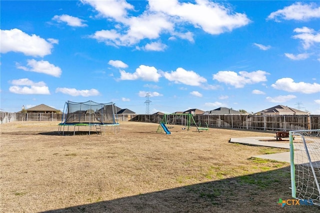 view of playground with a patio, a trampoline, and a lawn