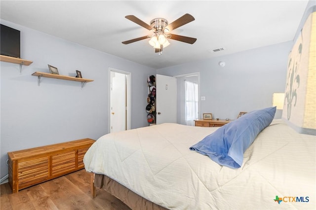 bedroom featuring wood finished floors and a ceiling fan