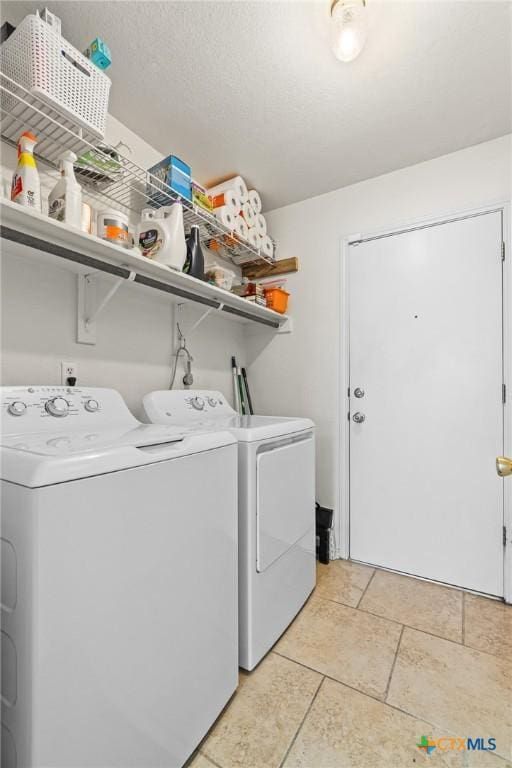 laundry area with washing machine and clothes dryer and laundry area