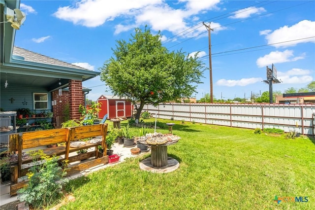 view of yard featuring a fenced backyard, an outdoor structure, and a storage shed