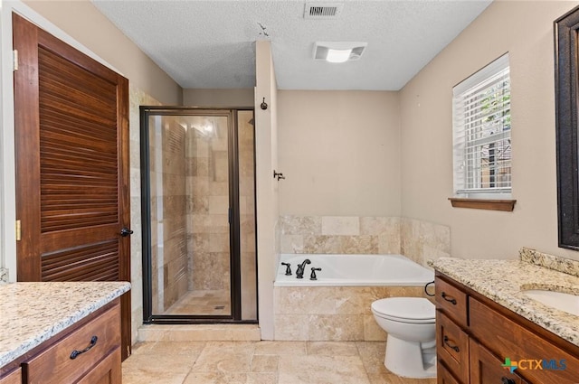 3002 Arrowhead Dr, Temple, TX 76502 - full bathroom with a stall shower, a bath, vanity, toilet, and a textured ceiling