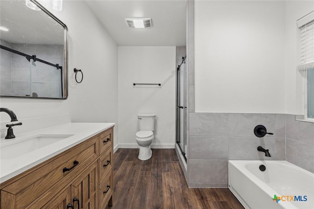 3002 Arrowhead Dr, Temple, TX 76502 - full bath with wood finished floors, toilet, a shower stall, a garden tub, and vanity