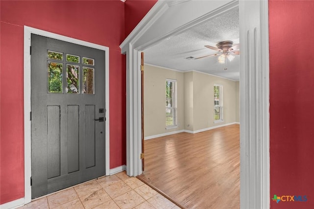 3002 Arrowhead Dr, Temple, TX 76502 - foyer entrance featuring ceiling fan, baseboards, ornamental molding, and a textured ceiling
