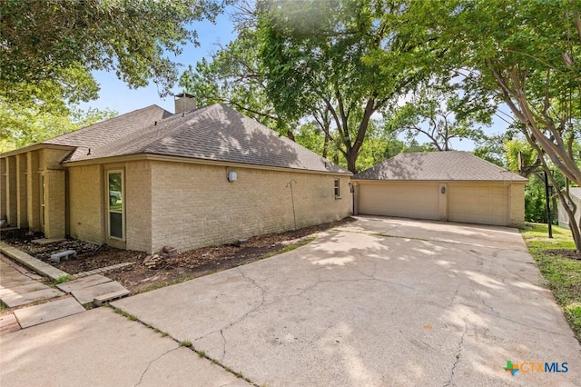 3002 Arrowhead Dr, Temple, TX 76502 - view of side of home featuring brick siding, a garage, a chimney, and a shingled roof