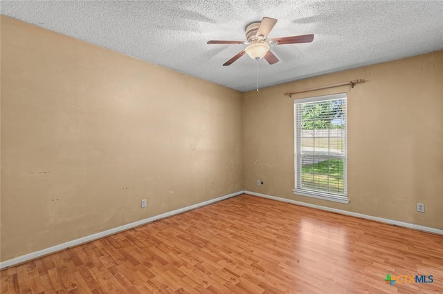3002 Arrowhead Dr, Temple, TX 76502 - unfurnished room featuring wood finished floors, baseboards, a textured ceiling, and a ceiling fan