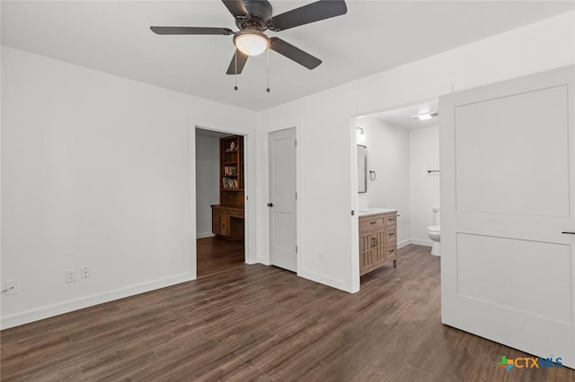 3002 Arrowhead Dr, Temple, TX 76502 - unfurnished bedroom featuring dark wood finished floors, baseboards, connected bathroom, and ceiling fan