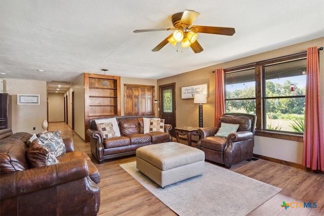 living room with ceiling fan and light hardwood / wood-style flooring