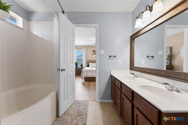 ensuite bathroom featuring double vanity, ensuite bathroom, and a sink