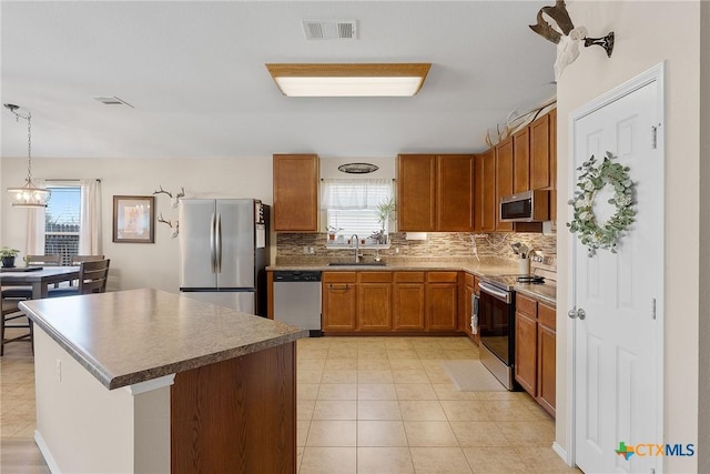 kitchen with a sink, stainless steel appliances, plenty of natural light, and visible vents