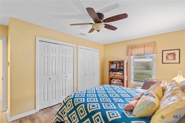 501 Hathaway St, Victoria, TX 77904 - bedroom with two closets, light wood-type flooring, and a ceiling fan