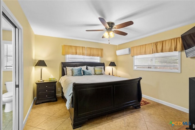 501 Hathaway St, Victoria, TX 77904 - bedroom featuring light tile patterned floors, a wall mounted air conditioner, a ceiling fan, and ensuite bath
