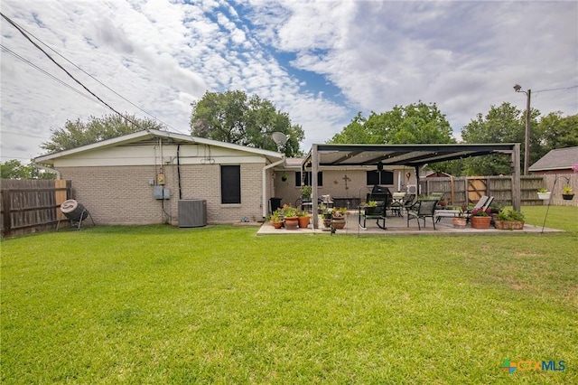 501 Hathaway St, Victoria, TX 77904 - back of property featuring a fenced backyard, brick siding, and a patio