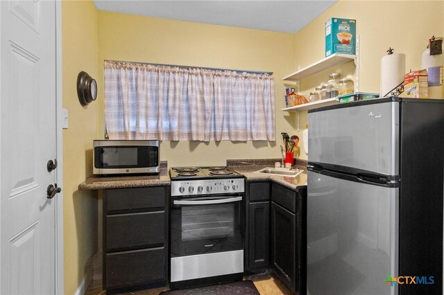501 Hathaway St, Victoria, TX 77904 - kitchen featuring appliances with stainless steel finishes and dark cabinetry