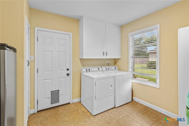 501 Hathaway St, Victoria, TX 77904 - washroom with washer and dryer, cabinet space, and light tile patterned flooring