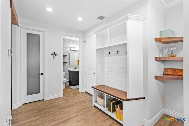 mudroom featuring baseboards, light wood-type flooring, visible vents, and recessed lighting