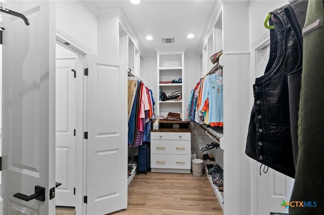 spacious closet with light wood-style floors and visible vents